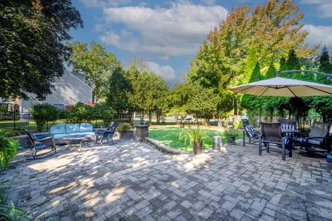 a view of a table and chairs under an umbrella in the patio