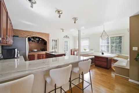 a large kitchen with a table and chairs