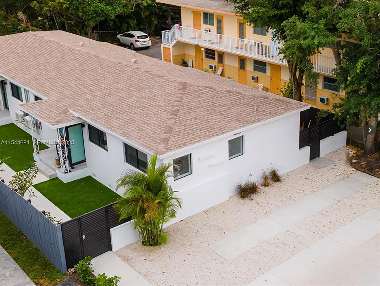 a aerial view of a house with a yard