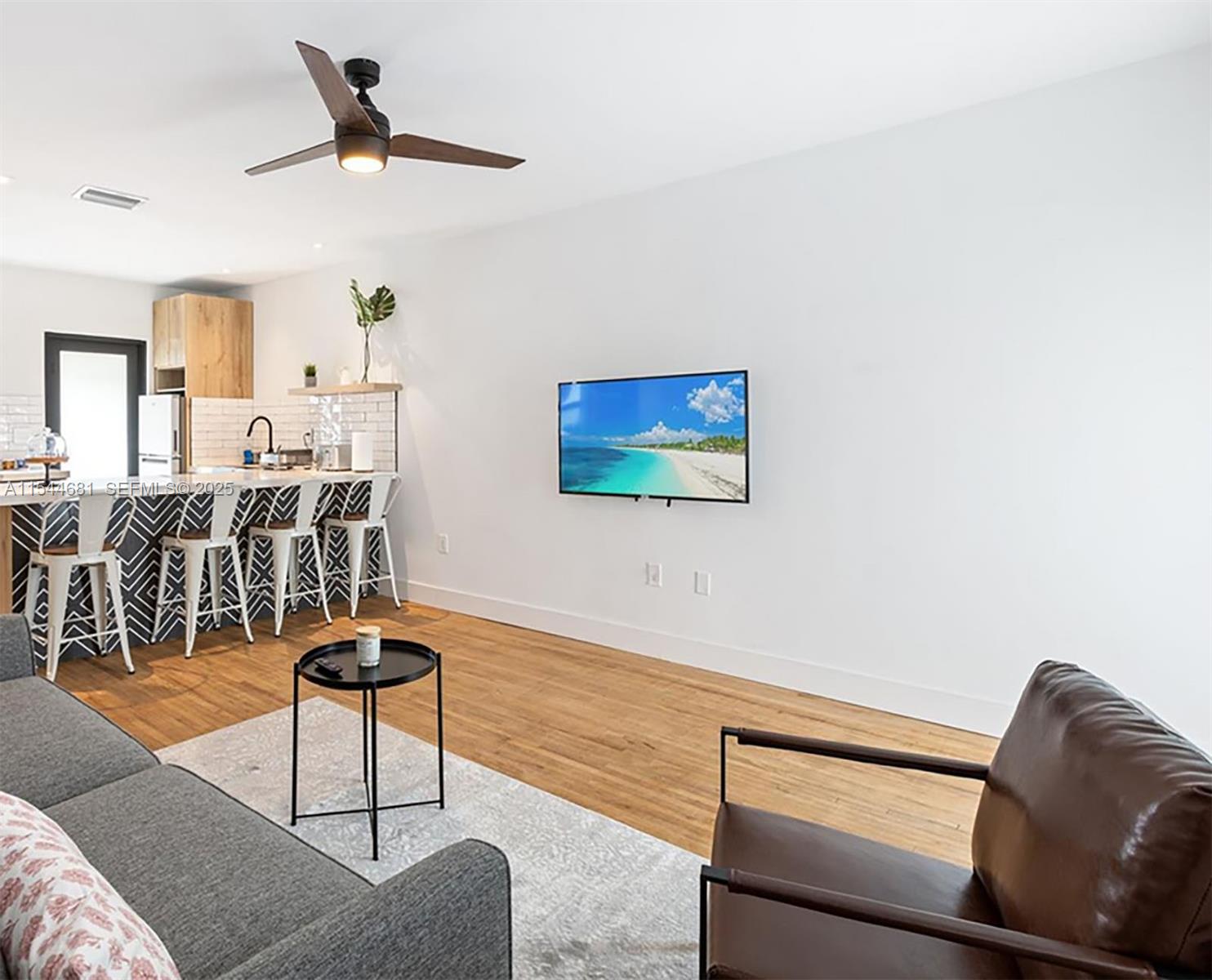 740 Southwest 9th Street, Unit 1 Miami, FL 33130 - Photo 3 of 34 a living room with furniture and a view of kitchen