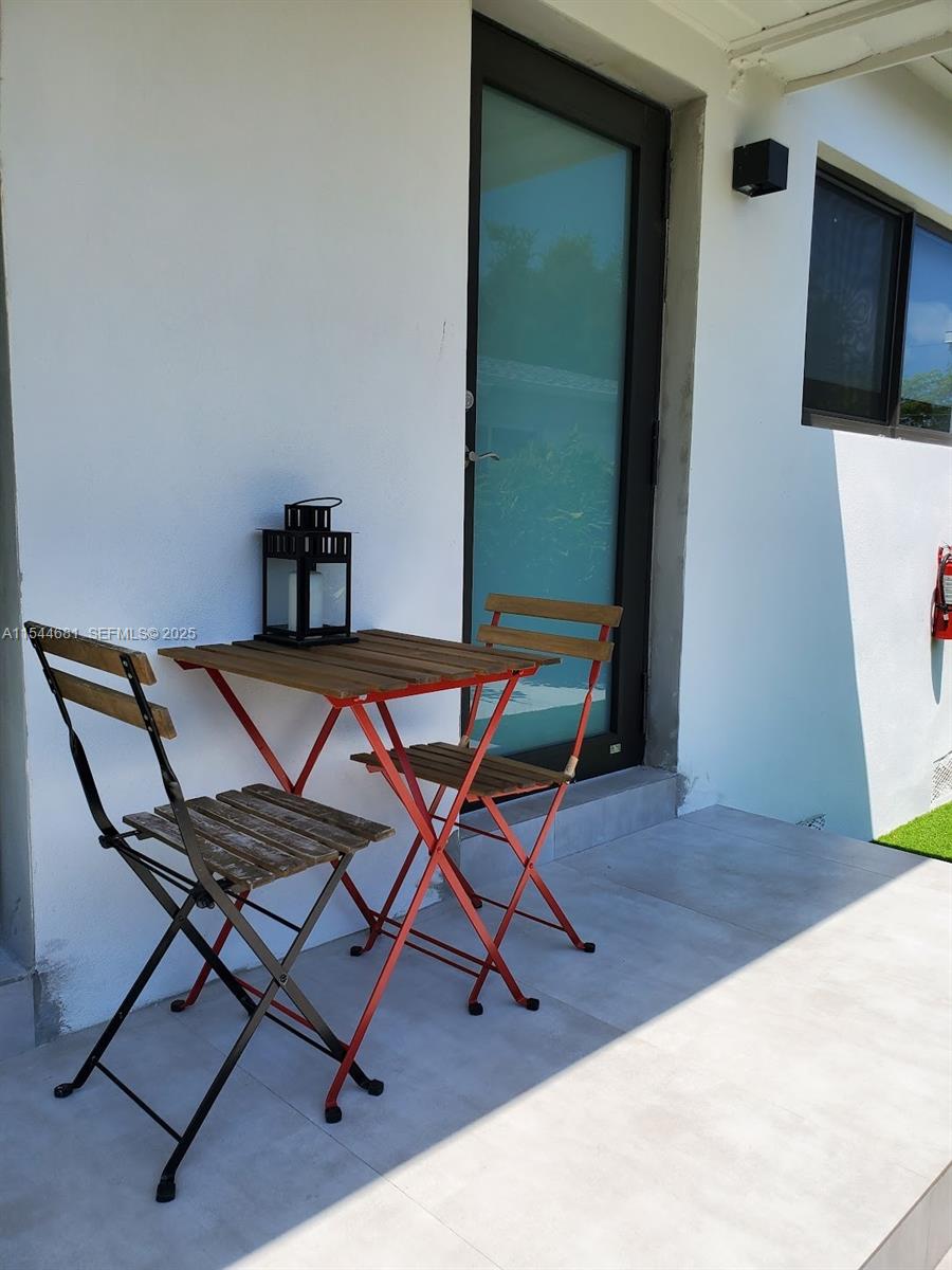 740 Southwest 9th Street, Unit 1 Miami, FL 33130 - Photo 33 of 34 a view of a workspace with furniture and wooden floor