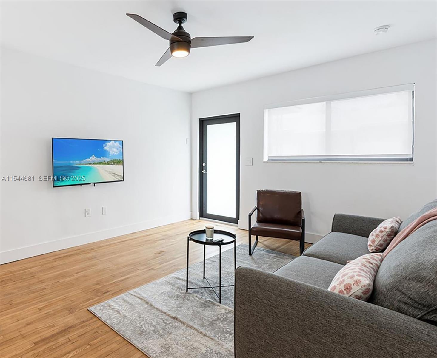 740 Southwest 9th Street, Unit 1 Miami, FL 33130 - Photo 5 of 34 a living room with furniture and a flat screen tv