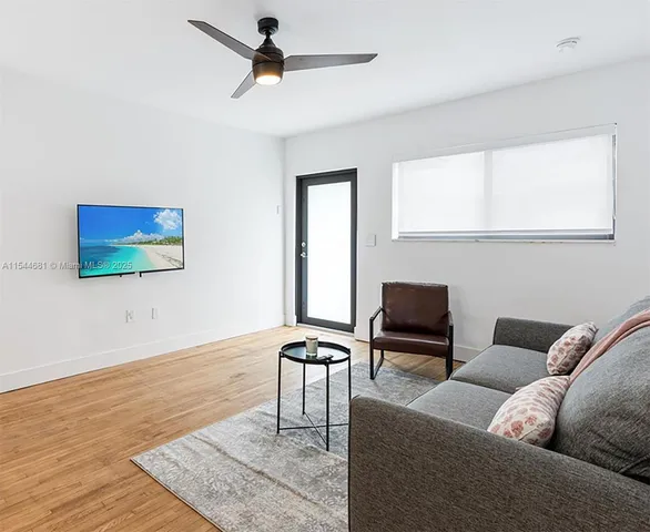 a living room with furniture and a flat screen tv