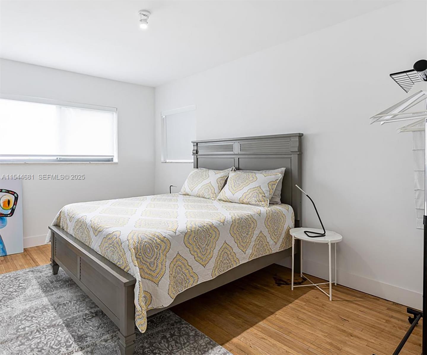 740 Southwest 9th Street, Unit 1 Miami, FL 33130 - Photo 6 of 34 a bed sitting in a bedroom next to a window