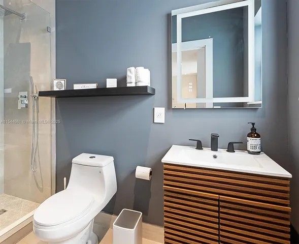 a bathroom with a sink a toilet and mirror