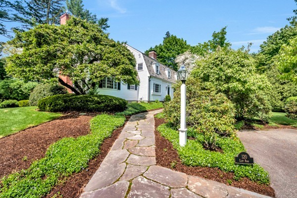 120 Cliff Road Wellesley, MA 02481 - Photo 3 of 25 a front view of a house with a yard and potted plants