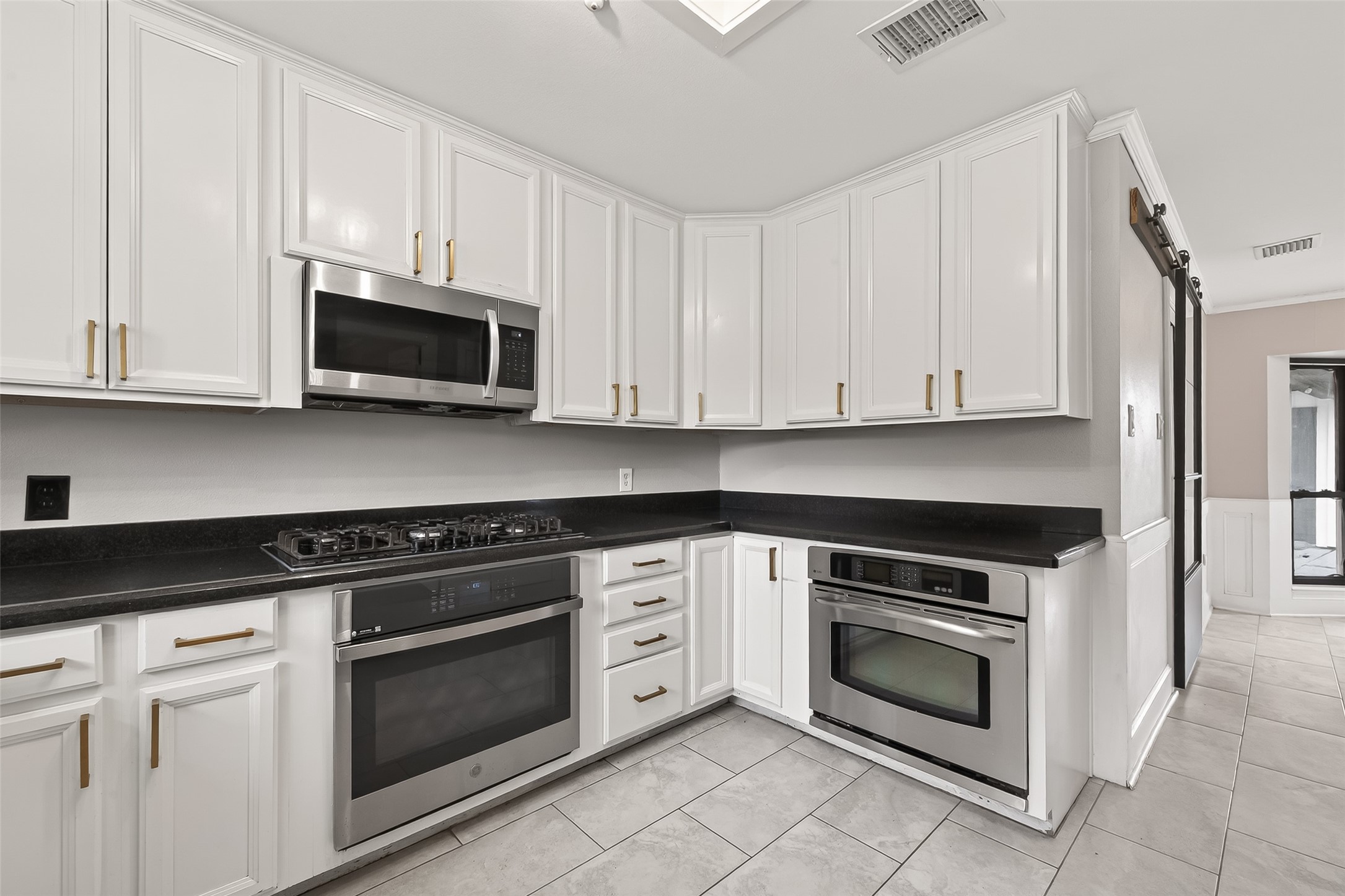 707 Montclair Boulevard Sugar Land, TX 77478 - Photo 11 of 50 a kitchen with white cabinets and stainless steel appliances