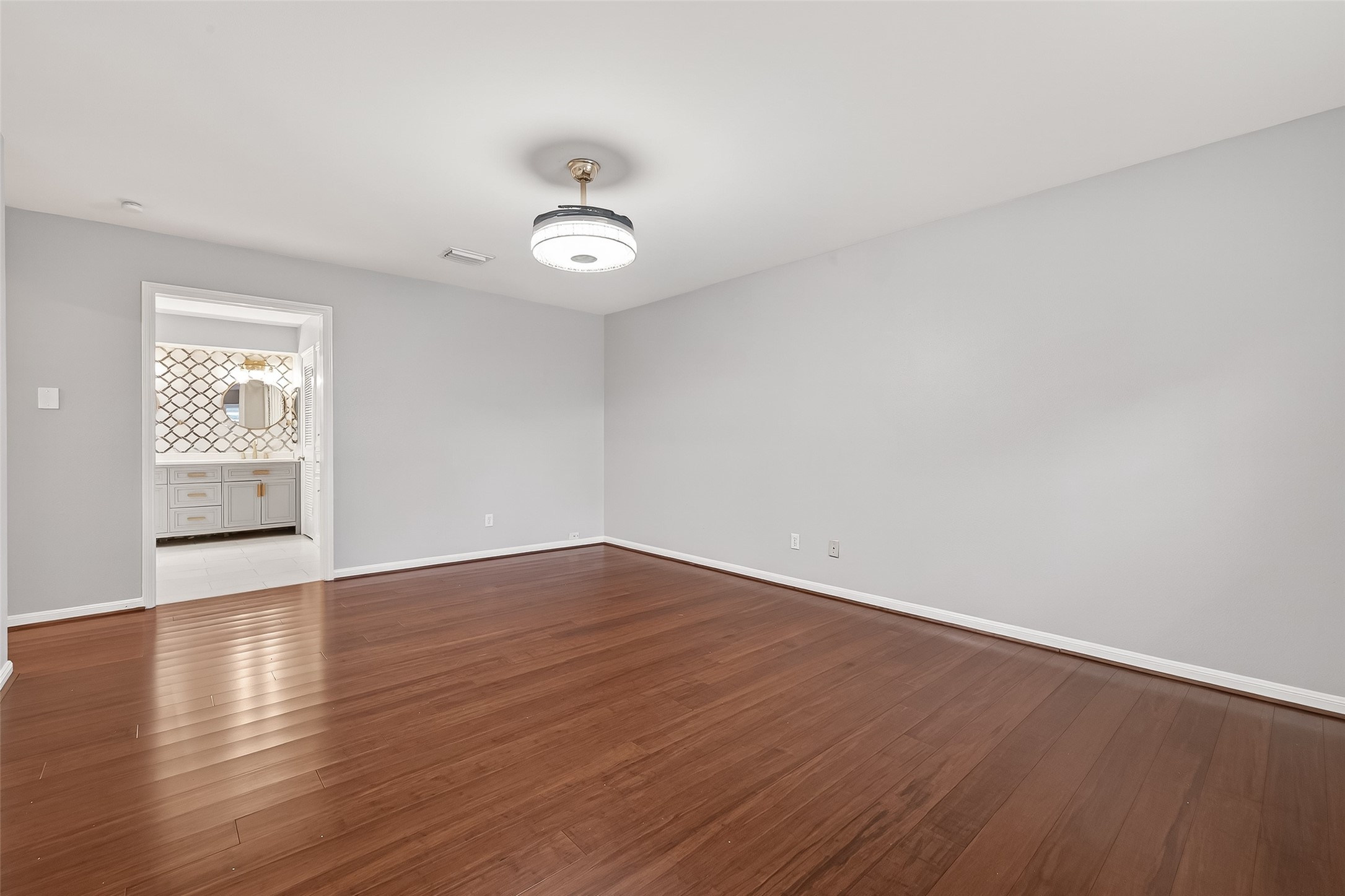 707 Montclair Boulevard Sugar Land, TX 77478 - Photo 21 of 50 an empty room with wooden floor and windows