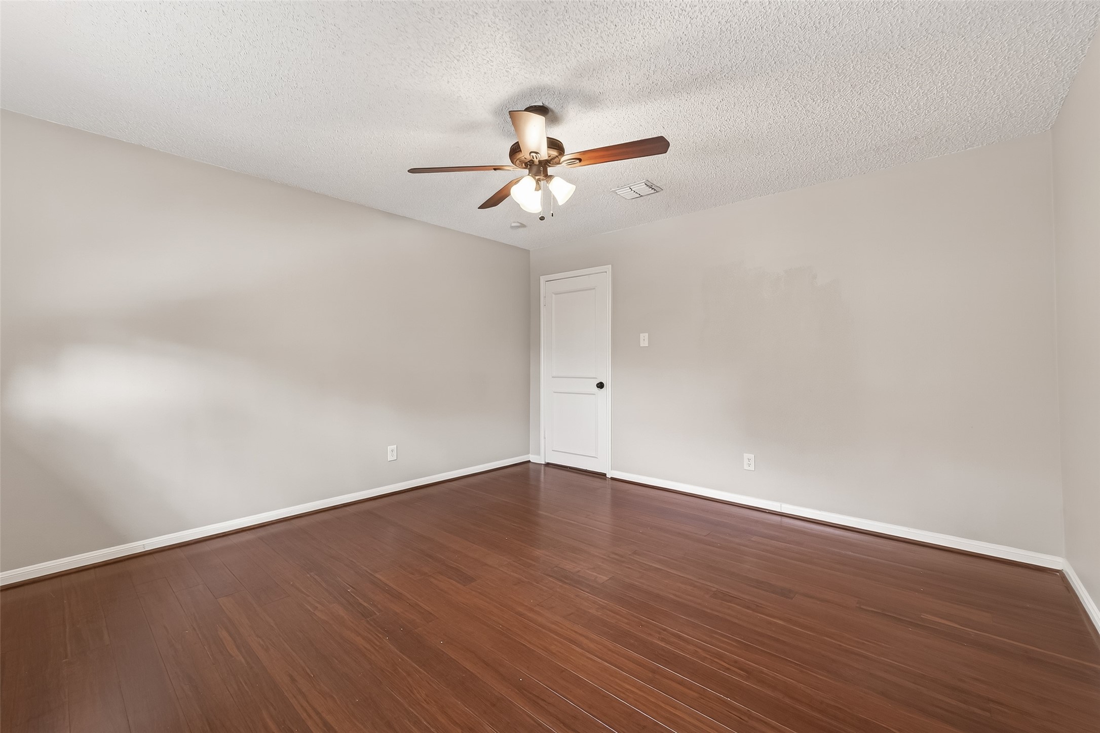 707 Montclair Boulevard Sugar Land, TX 77478 - Photo 25 of 50 a view of an empty room with wooden floor