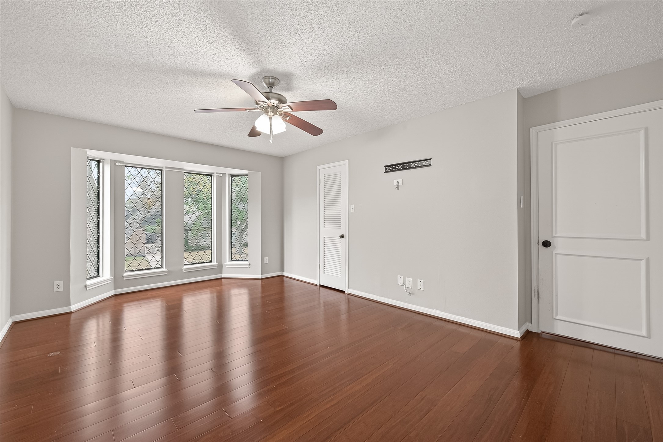 707 Montclair Boulevard Sugar Land, TX 77478 - Photo 30 of 50 a view of an empty room with wooden floor and a window