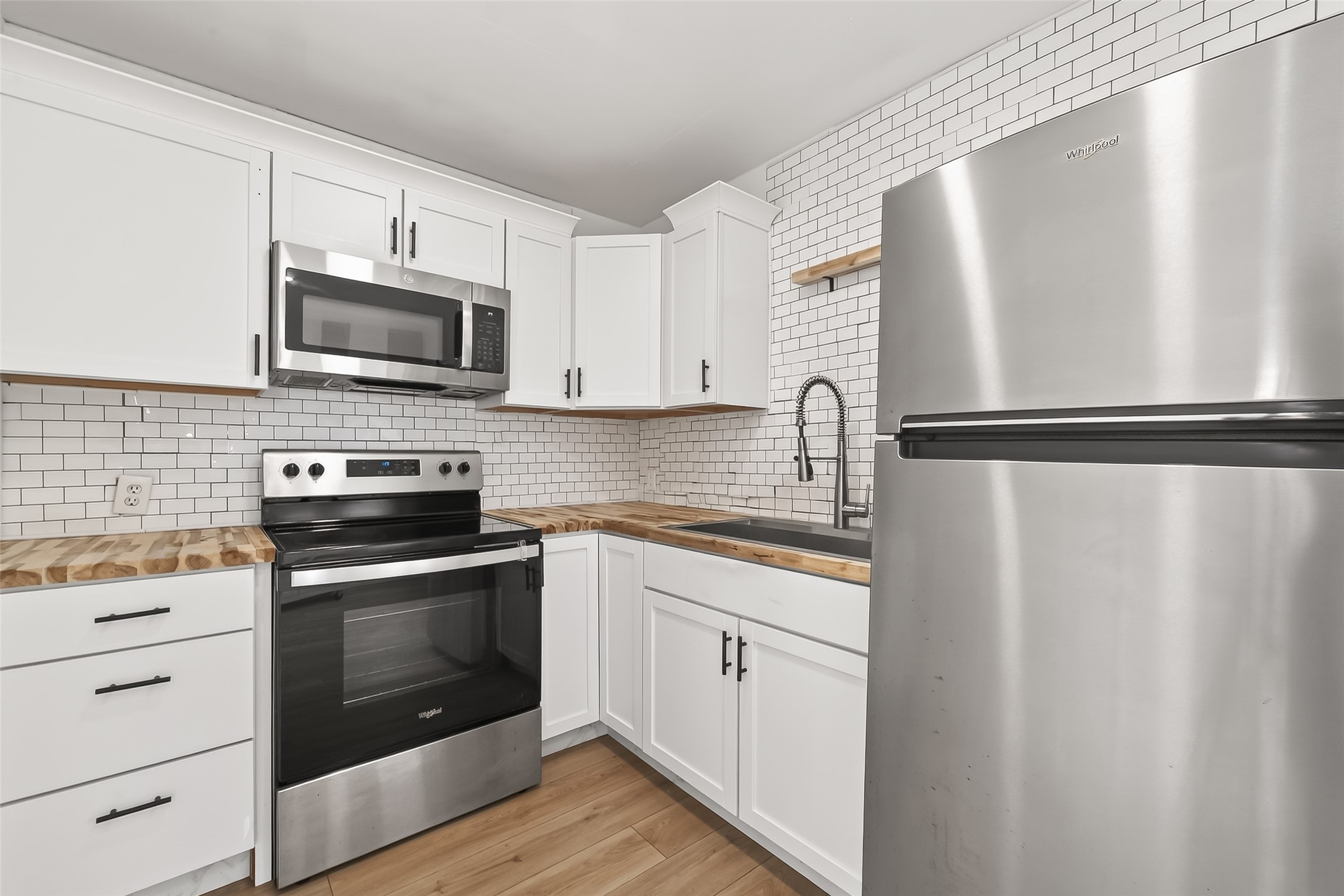 707 Montclair Boulevard Sugar Land, TX 77478 - Photo 36 of 50 a kitchen with a refrigerator sink and microwave