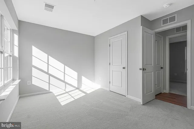 a view of a livingroom with an empty space and a window