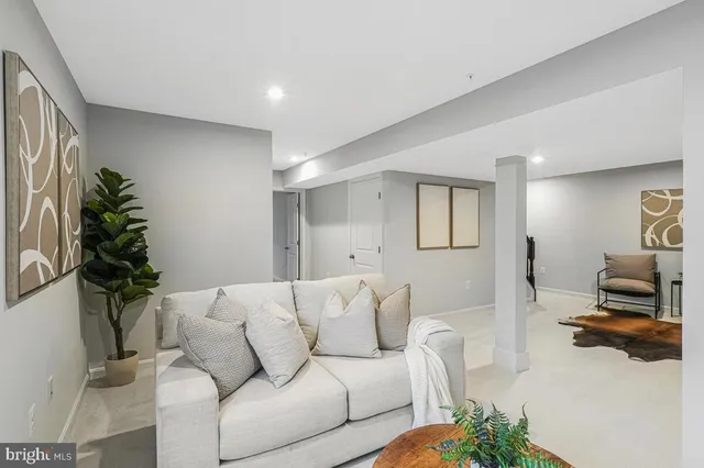 a living room with furniture and a potted plant