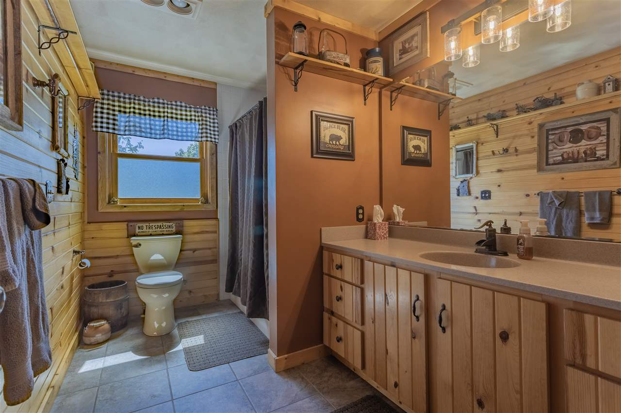 12918 Edwardsville Road Winnebago, IL 61088 - Photo 14 of 33 a bathroom with a granite countertop sink a toilet and a mirror