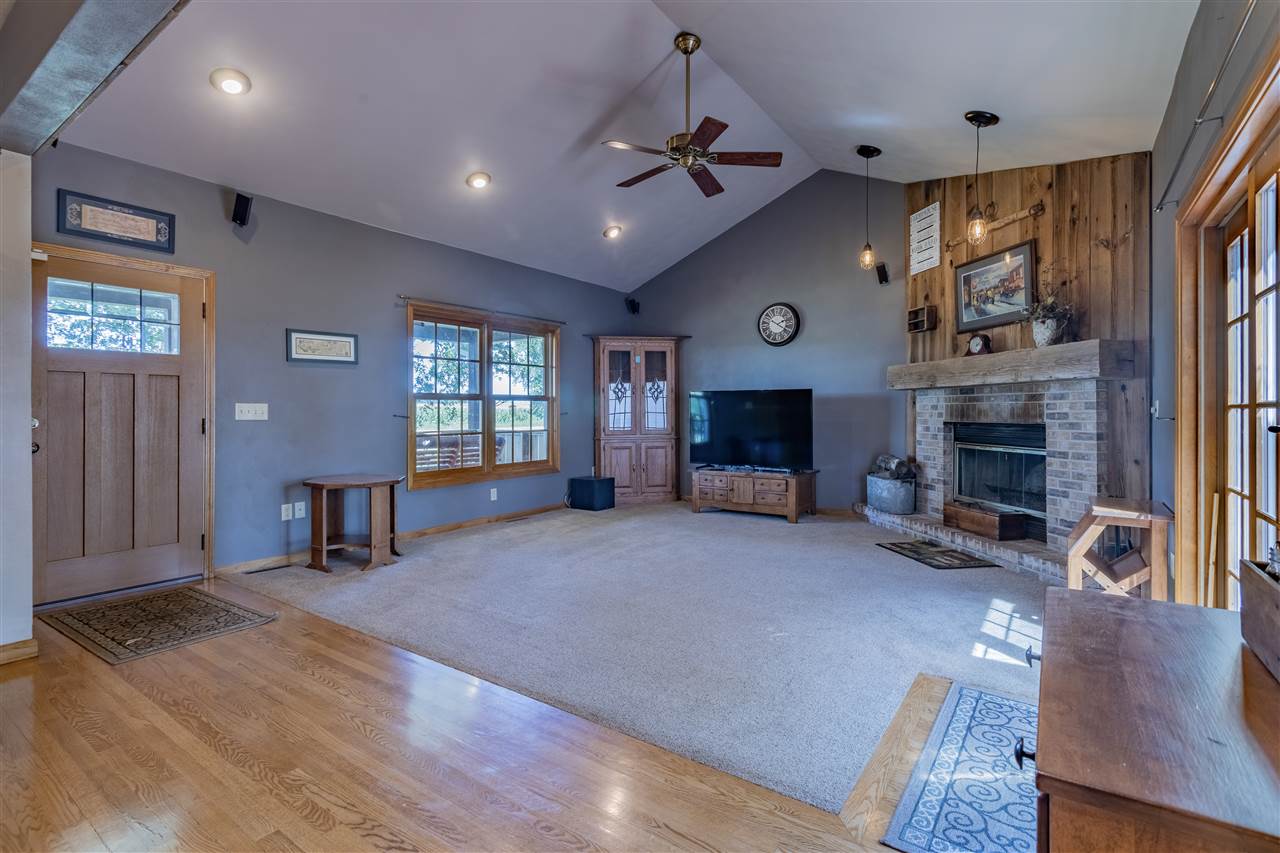12918 Edwardsville Road Winnebago, IL 61088 - Photo 3 of 33 a large living room with furniture and a fireplace