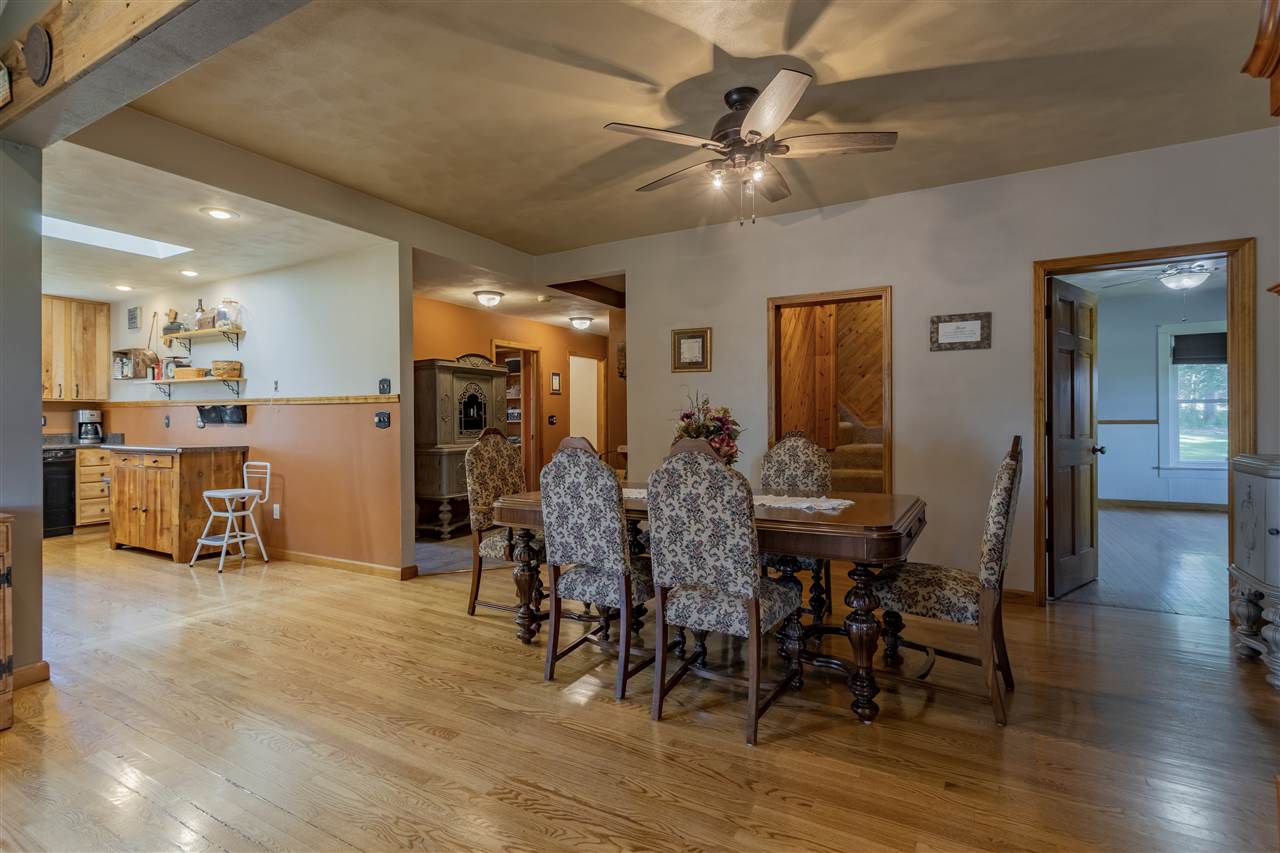 12918 Edwardsville Road Winnebago, IL 61088 - Photo 8 of 33 a view of a dining room with furniture and wooden floor