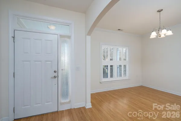 a view of a room with wooden floor and windows