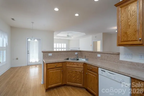 a kitchen with a sink a counter space and cabinets