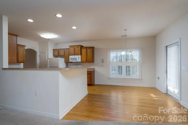 a view of a kitchen with microwave and cabinets