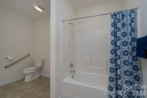 a bathroom with a toilet and a shower