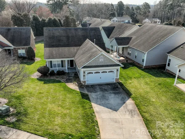 a aerial view of a house with a yard table and chairs