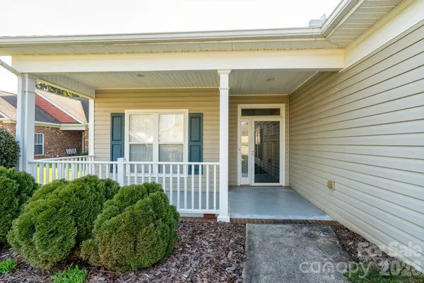 a view of a porch with furniture and floor to ceiling window
