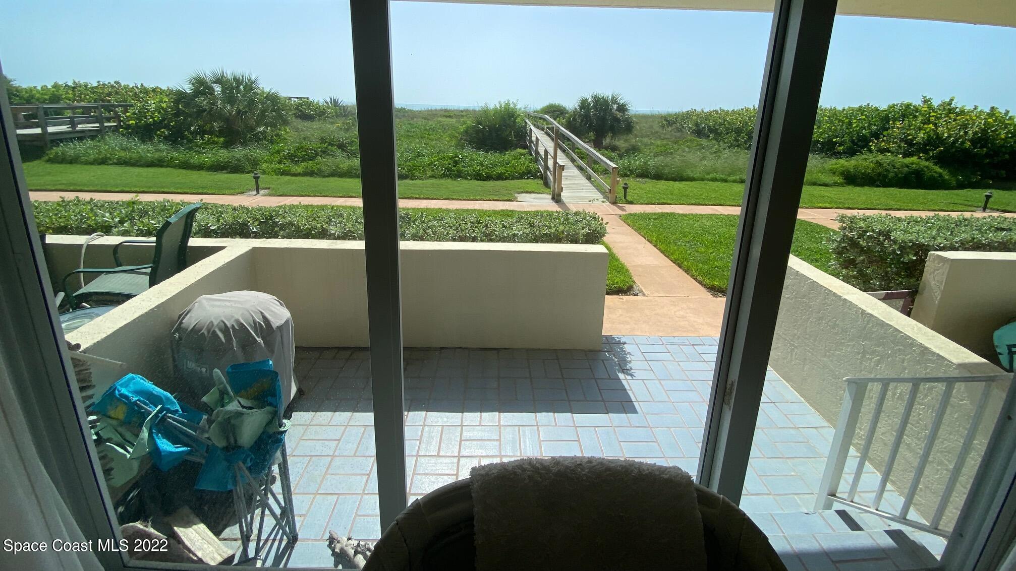 5050 Ocean Beach Boulevard, Unit 104 Cocoa Beach, FL 32931 - Photo 12 of 15 a view of balcony and patio
