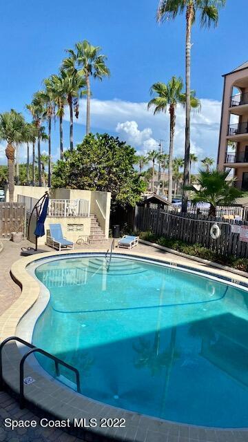 5050 Ocean Beach Boulevard, Unit 104 Cocoa Beach, FL 32931 - Photo 13 of 15 a view of swimming pool with outdoor seating and plants