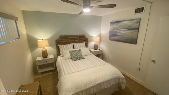 a bedroom with a bed and a mirror