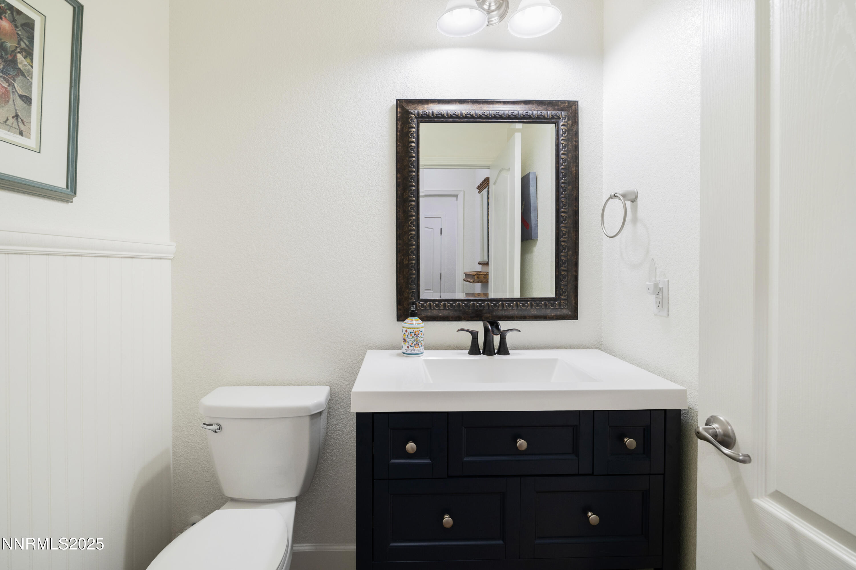 10260 Rollins Drive Reno, NV 89521 - Photo 23 of 44 a bathroom with a toilet a sink and mirror