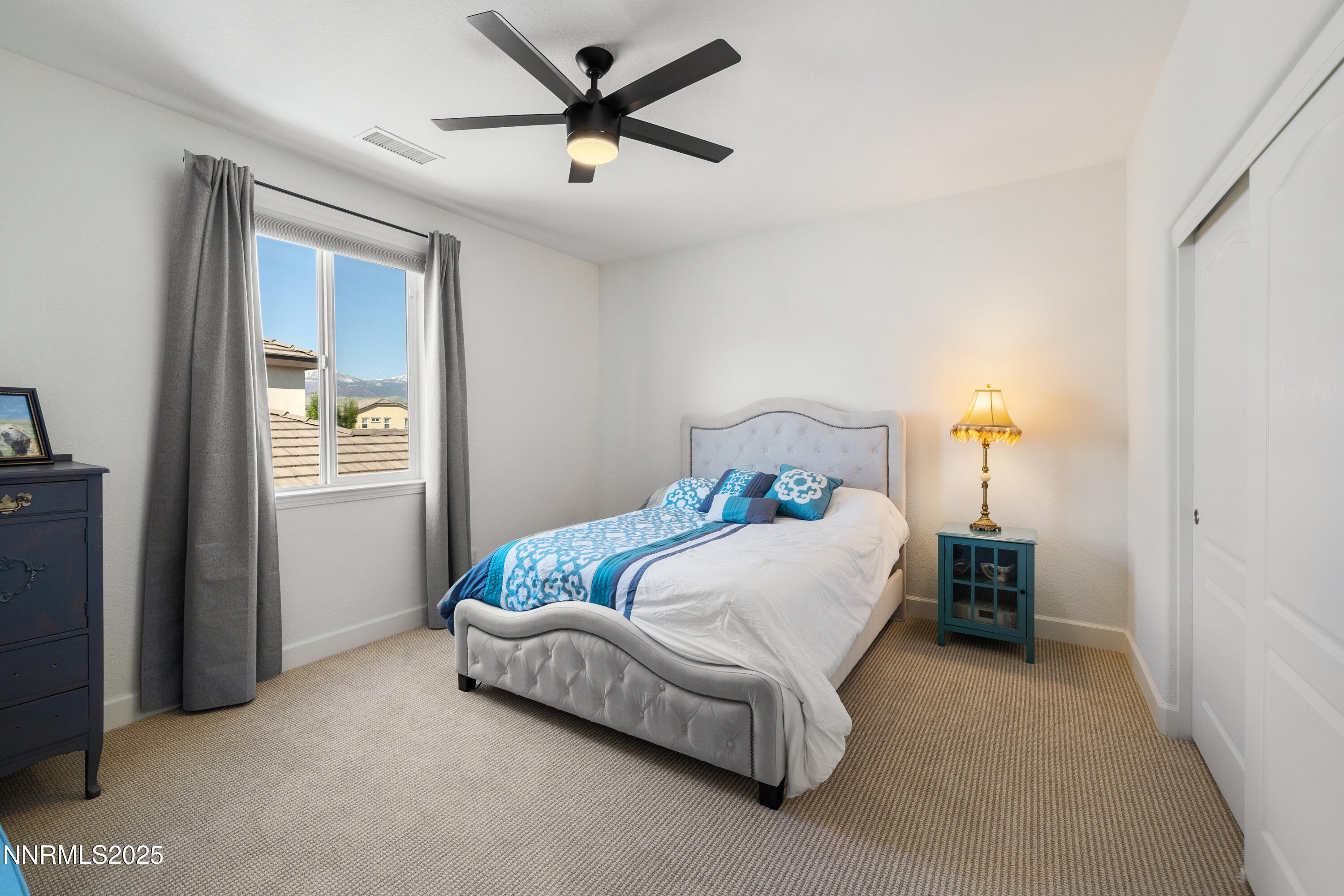 10260 Rollins Drive Reno, NV 89521 - Photo 25 of 44 a bedroom with a bed and a chandelier