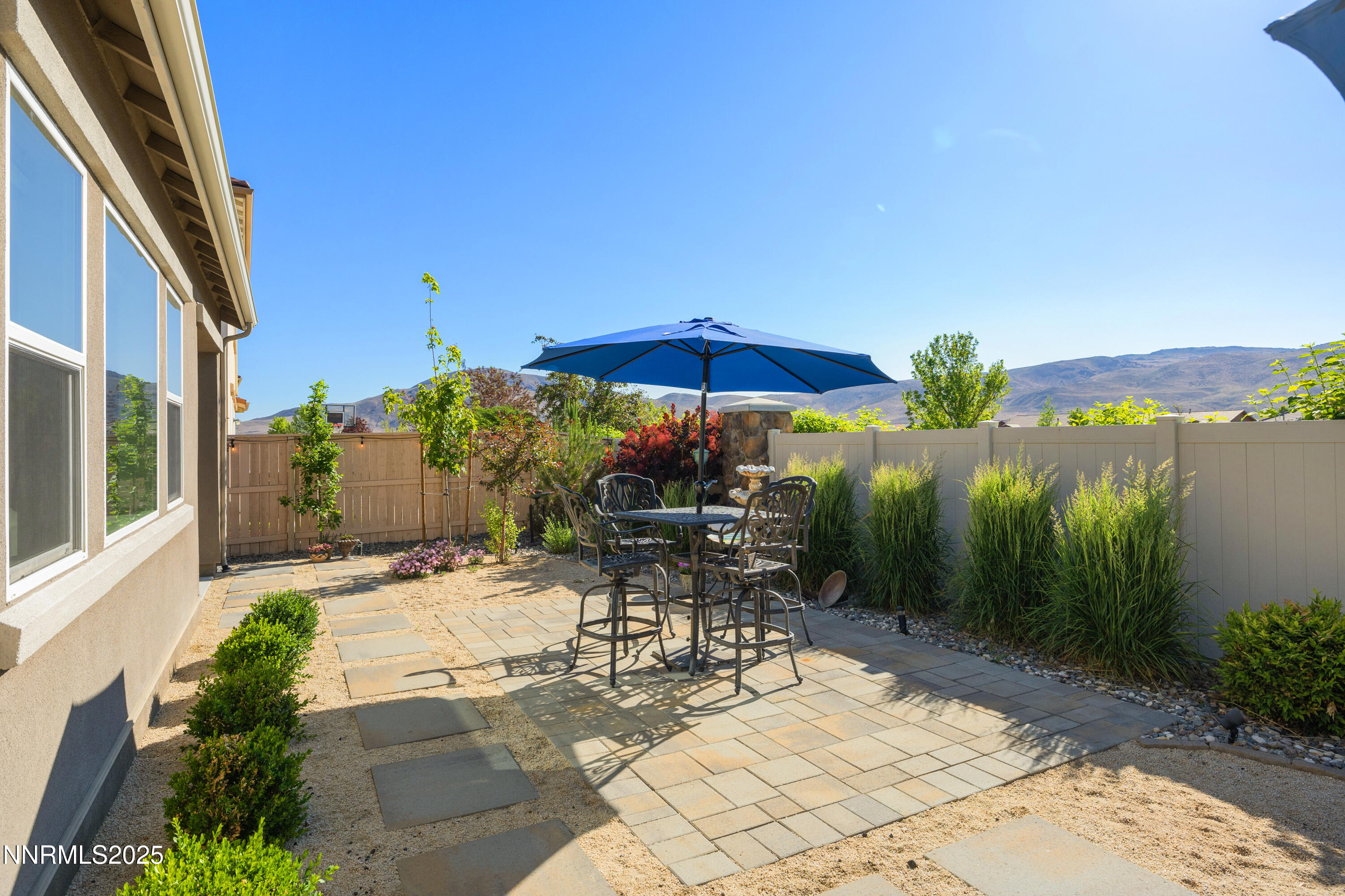 10260 Rollins Drive Reno, NV 89521 - Photo 31 of 44 a view of a patio with chairs and table under an umbrella