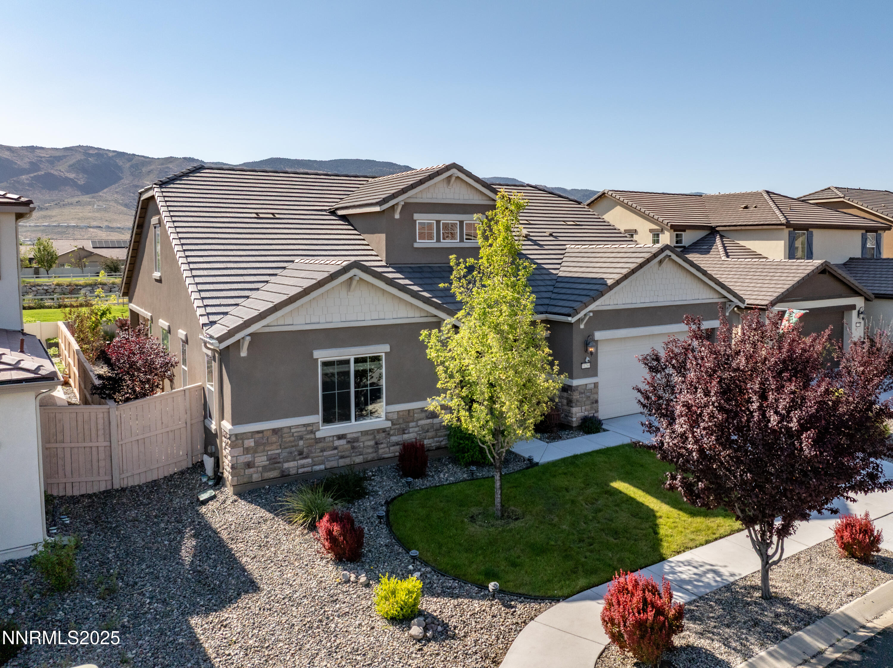 10260 Rollins Drive Reno, NV 89521 - Photo 39 of 44 a front view of a house with a yard and garage
