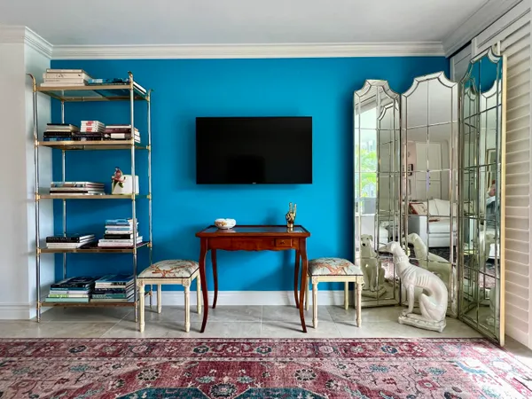 a living room with furniture and flowers