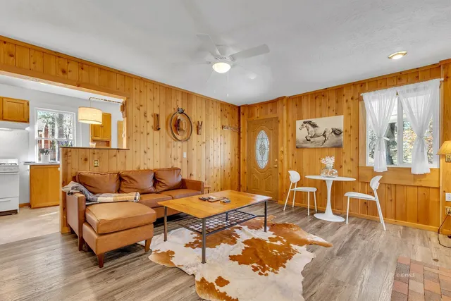 a living room with patio furniture and a large window