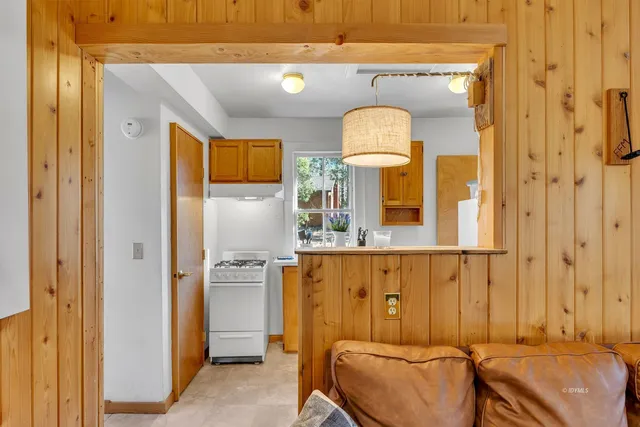 a kitchen with stainless steel appliances granite countertop cabinets and a potted plant