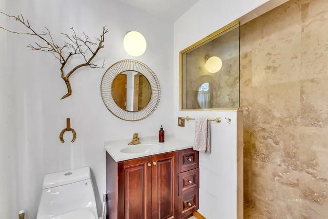 a bathroom with a sink a mirror and a shower