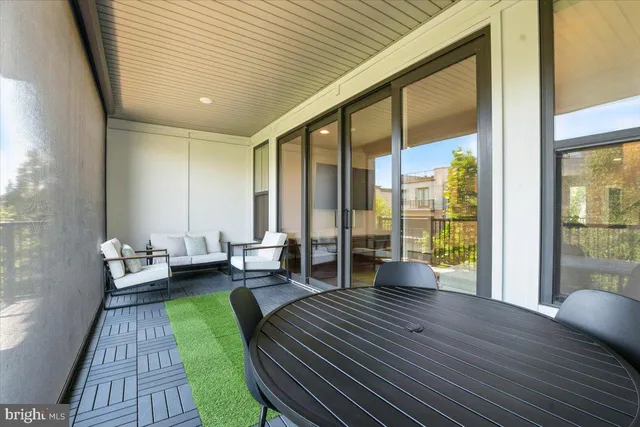 a living room with furniture and large windows