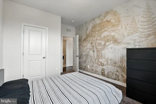 a bedroom with a bed and a dresser