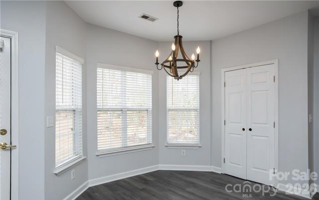 815 Knightsbridge Road Fort Mill, SC 29708 - Photo 12 of 30 a view of a room with wooden floor ceiling fan and windows