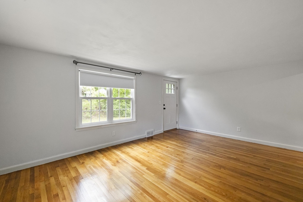 1652 Parker Street Springfield, MA 01128 - Photo 11 of 22 a view of an empty room with wooden floor and a window