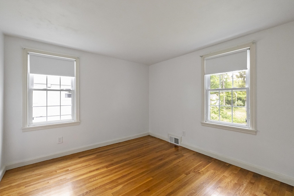 1652 Parker Street Springfield, MA 01128 - Photo 14 of 22 a view of an empty room with wooden floor and a window