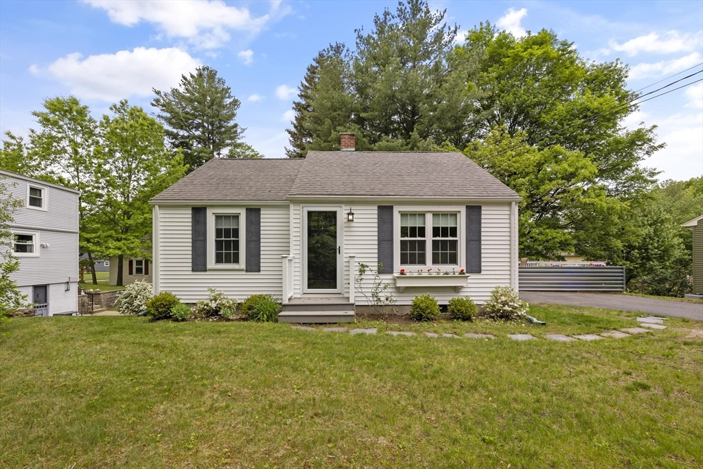 1652 Parker Street Springfield, MA 01128 - Photo 3 of 22 a front view of a house with a garden and porch