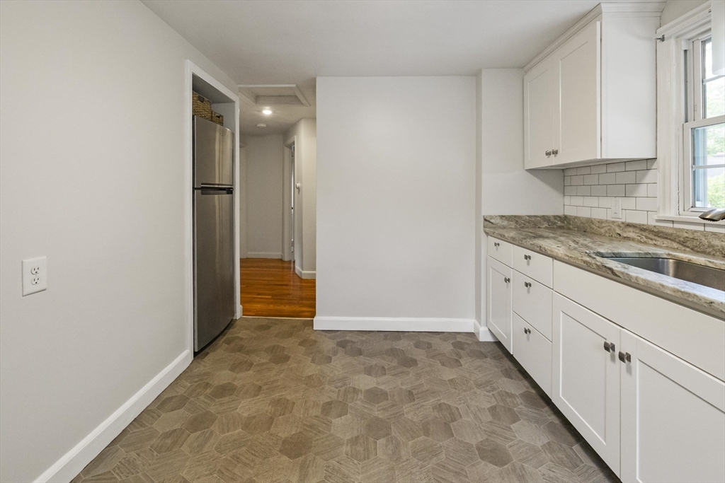 1652 Parker Street Springfield, MA 01128 - Photo 7 of 22 a view of a kitchen with white cabinets