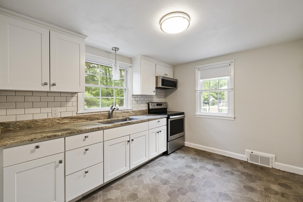 1652 Parker Street Springfield, MA 01128 - Photo 8 of 22 a kitchen with sink cabinets and window