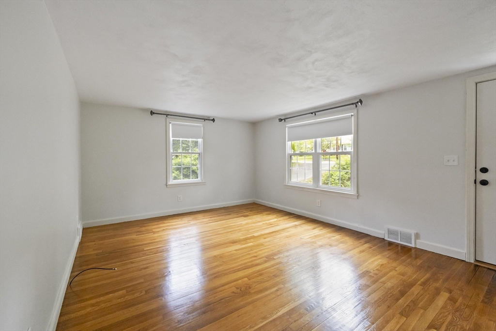 1652 Parker Street Springfield, MA 01128 - Photo 10 of 22 an empty room with wooden floor and windows