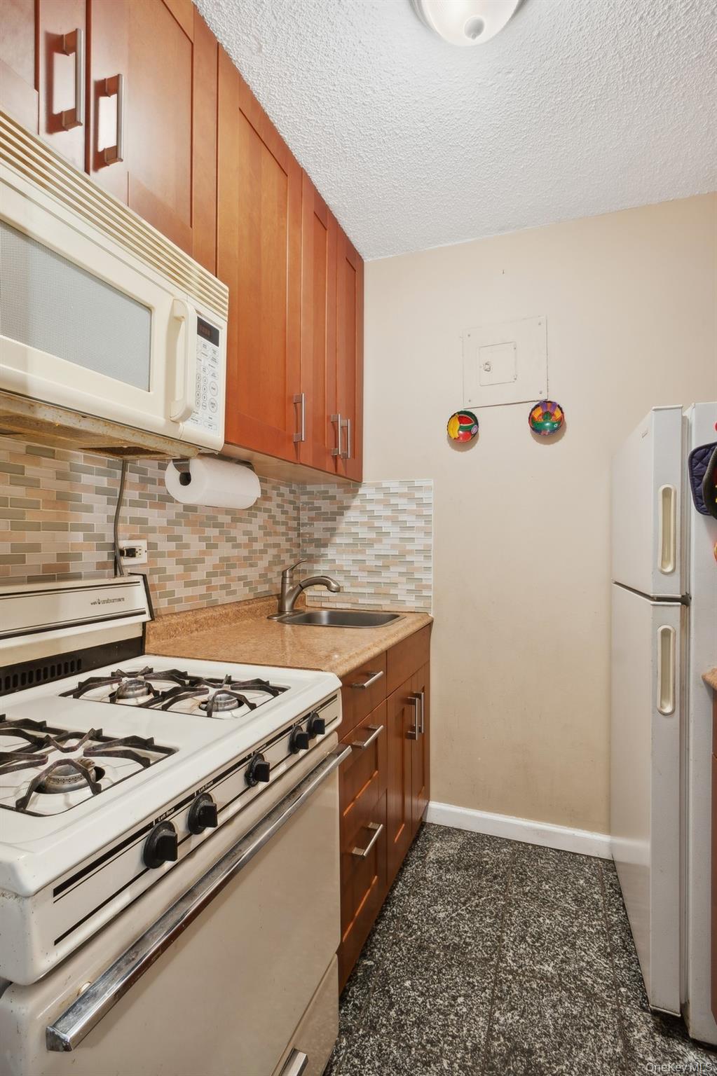 39-60 54th Street, Unit 3B Queens, NY 11377 - Photo 4 of 6 a kitchen with a stove and a sink