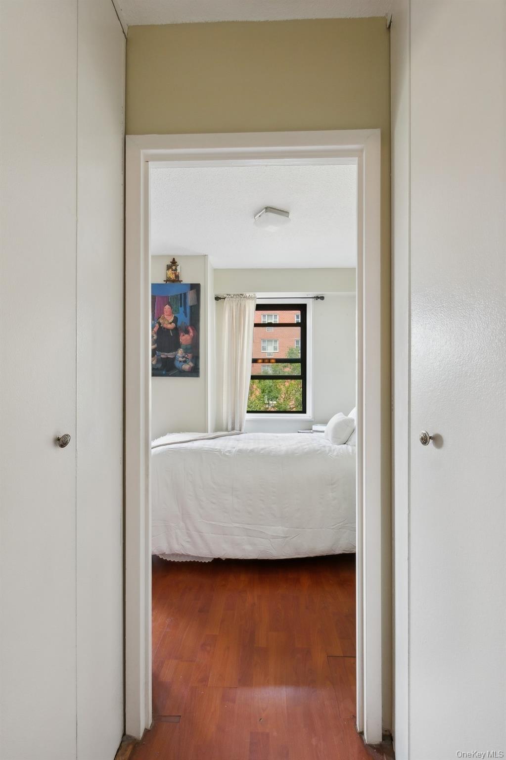 39-60 54th Street, Unit 3B Queens, NY 11377 - Photo 5 of 6 a living room with a bed and a window