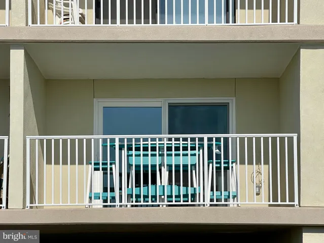a view of a chairs and table in the balcony