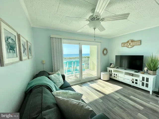 a bedroom with furniture and two large window